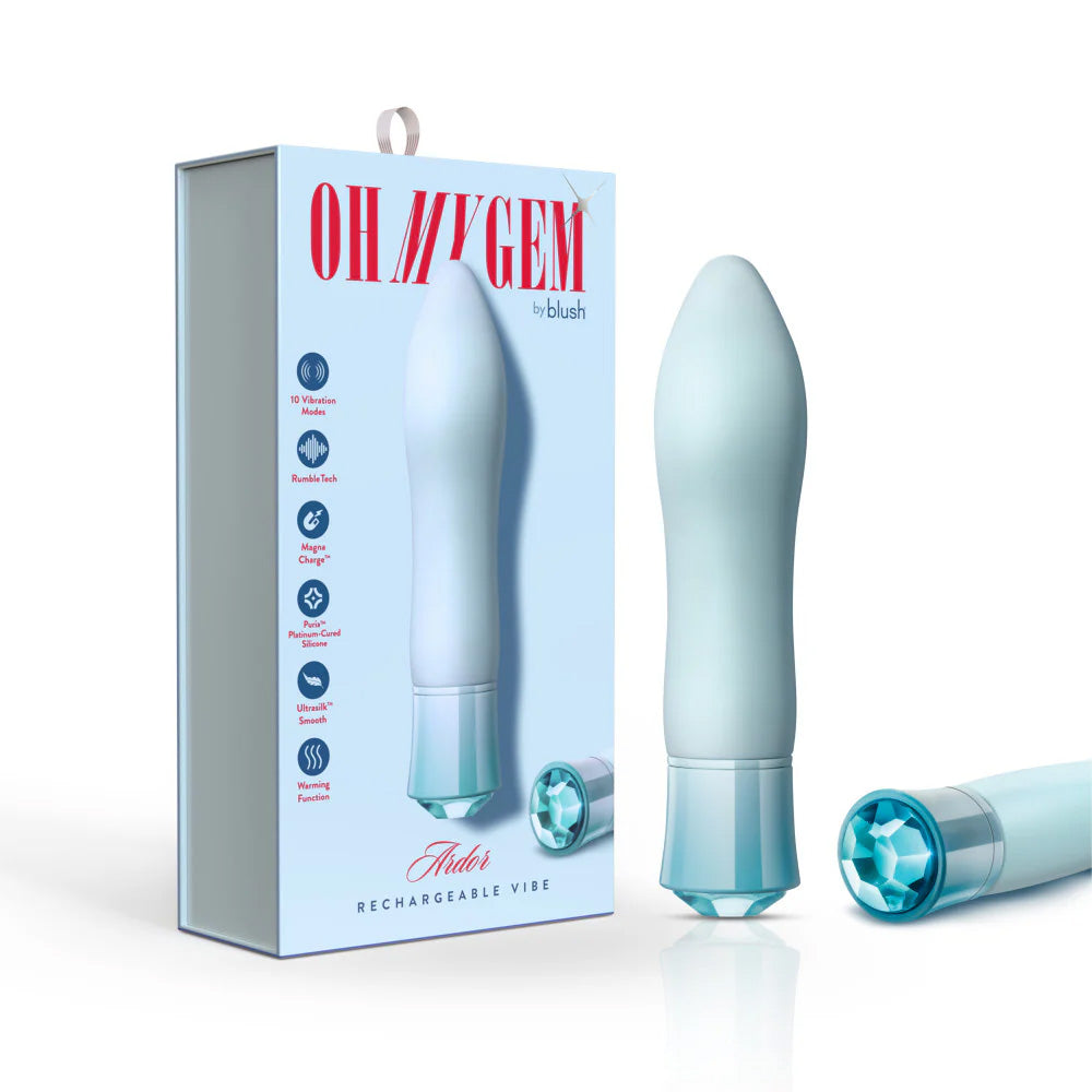 Retail display of Singapore Blush Oh My Gem blue vibrator alongside its branded box, featuring callouts for RumbleTech™, Magna Charge™, and UltraSilk®—a sleek, giftable vibe designed for LGBTQIA+ intimacy.