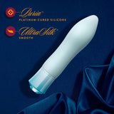 Singapore Blush Oh My Gem blue edition displayed on deep blue satin, emphasizing its Puria™ platinum-cured silicone and UltraSilk® finish—crafted for elegant, safe solo pleasure across gender expressions.