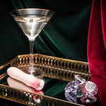 Glamorous scene with Singapore Blush Oh My Gem on a mirrored tray beside a martini glass and crystal gems—celebrating queer sensuality, solo indulgence, and high-end intimacy aesthetics.