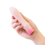 Close-up of hand holding the Singapore Blush Oh My Gem pink vibrator, highlighting its textured shaft and sleek size—perfect for beginners, queer folks, and those exploring G-spot pleasure in a gender-affirming way.