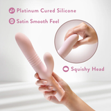 Close-up of the Singapore Blush Fraya vibrator being squeezed to show its squishy head and satin-smooth, platinum-cured silicone—designed for comfort-focused, body-safe play ideal for lesbian and tomboy users.