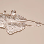 Close-up of glistening HARU lubricant with silky texture and visible bubbles, showcasing hydrating, body-safe ingredients that elevate intimate moments for all gender expressions.