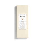 Minimalist cream-toned box of HARU Dewy water-based lubricant, featuring Ylang Ylang extract for silky, sensual intimacy—ideal for enhancing comfort and pleasure during queer and gender-affirming intimacy.