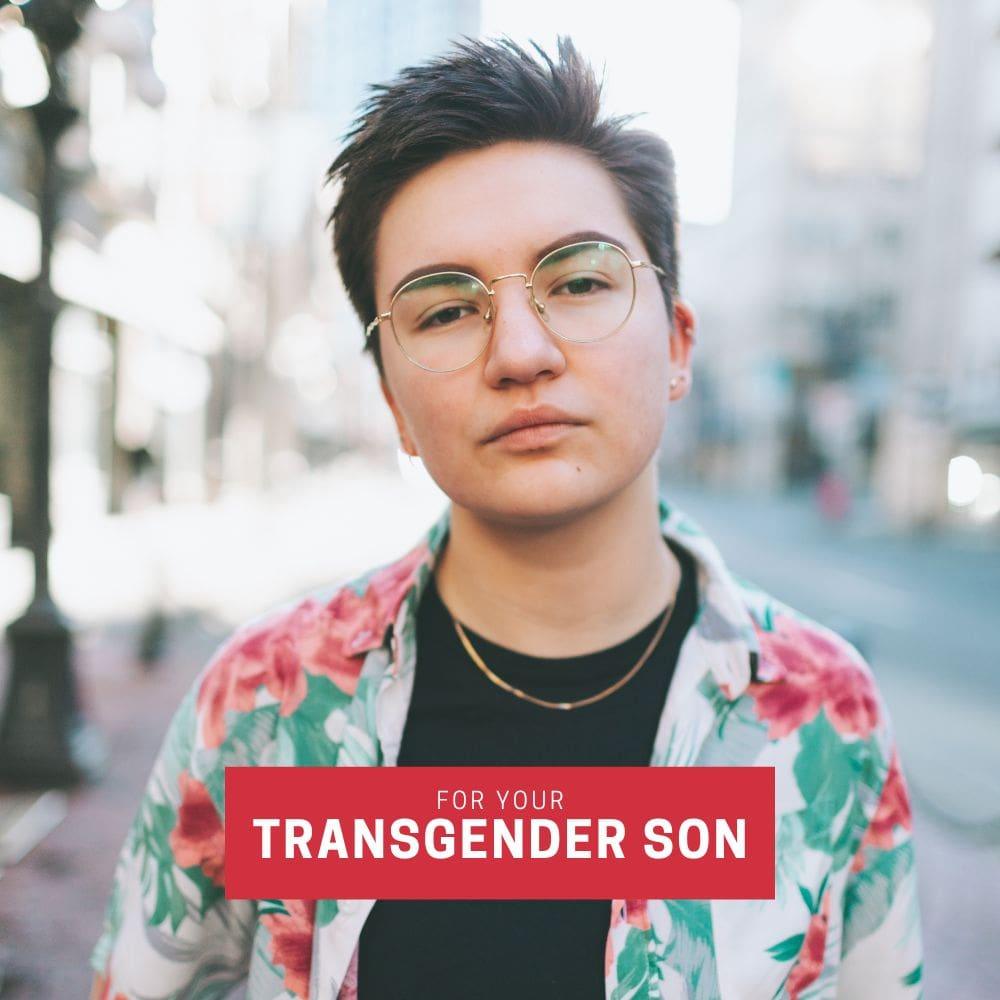 Trans man in floral shirt and gold-rimmed glasses standing confidently in natural light with overlay text “For Your Transgender Son”—highlighting TOMSCOUT’s digital gift card as a gender-affirming, practical gift for transmasc individuals.