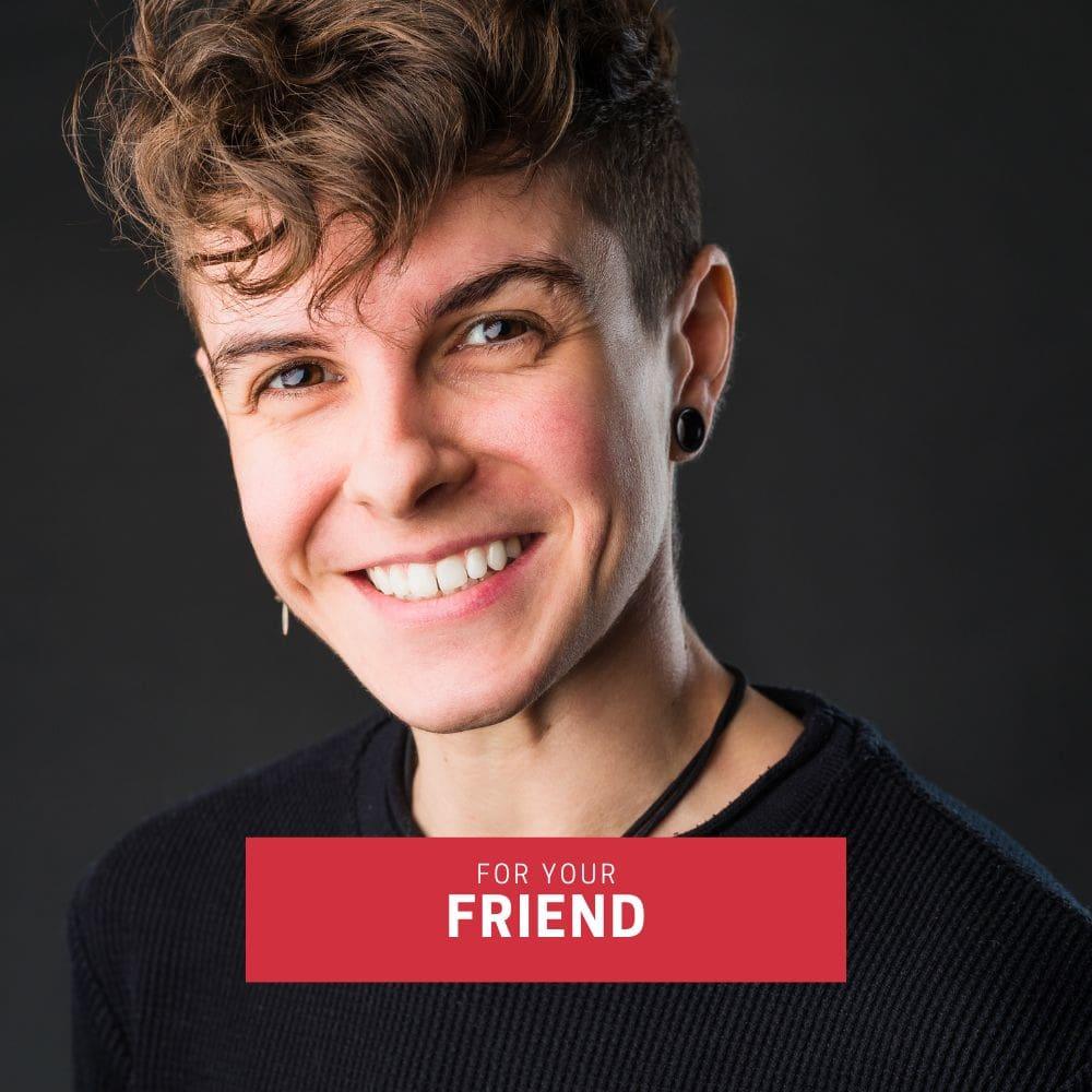 Cheerful tomboy with undercut hairstyle and dark top, smiling warmly in a studio portrait—ideal for promoting the TOMSCOUT gift card as a supportive, affirming gift for trans, FTM, and androgynous friends.