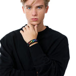 Stylish model elegantly wearing the TOMSCOUT LGBTQ+ Pride Paracord Bracelet with a striking rainbow design, a sustainable and fashionable accessory for expressing LGBTQ+ pride and solidarity.
