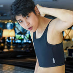 Looking directly into the lens with bold, unshakable presence, a trans man wears a TOMSCOUT binder that seamlessly contours the torso—emphasizing strength, style, and gender euphoria.