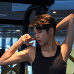 In a moment of post-workout serenity, a non-binary person stretches in a TOMSCOUT compression top, showcasing toned arms and breathable, moisture-wicking fabric ideal for active lifestyles.