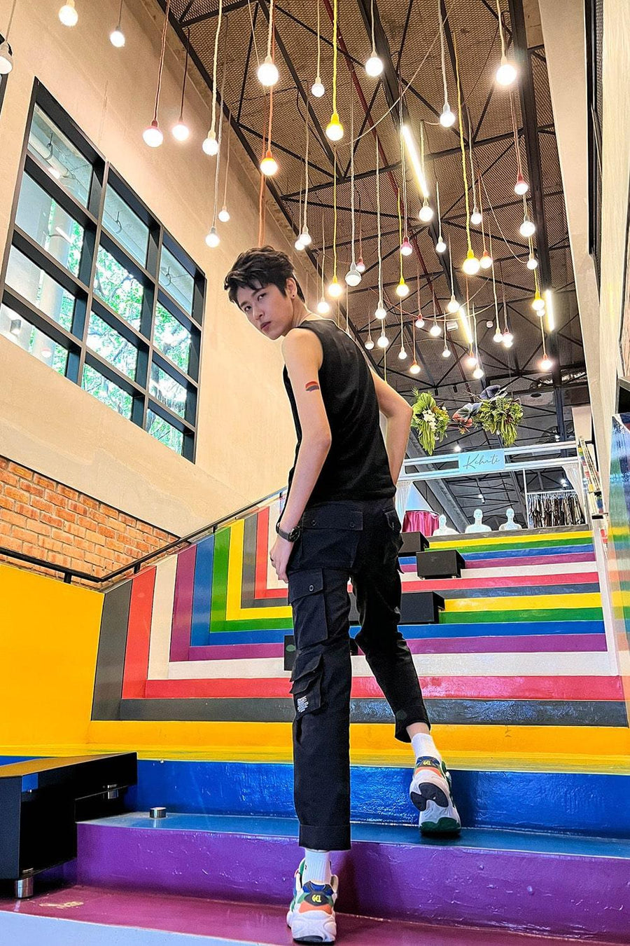 A non-binary androgynous tomboy, transgender man wearing a black color of a TOMSCOUT 20cm bandage 2 IN 1 Tank Top Chest Binder to fight body dysphoria, TOMSCOUT INSPIRED bandage binder.