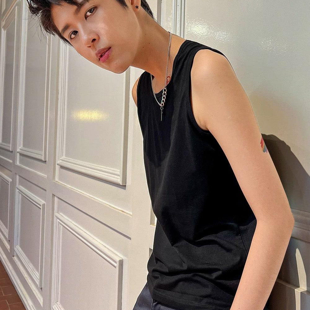 A non-binary androgynous tomboy, transgender man wearing a black color of a TOMSCOUT 20cm bandage 2 IN 1 Tank Top Chest Binder to fight body dysphoria, TOMSCOUT INSPIRED bandage binder.