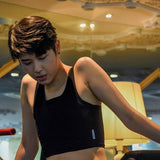 A non-binary androgynous tomboy, transgender man wearing a black color of a bandage TOMSCOUT 20cm bandage Chest Binder to fight body dysphoria and working out with the binder, TOMSCOUT STRENGTH bandage binder.