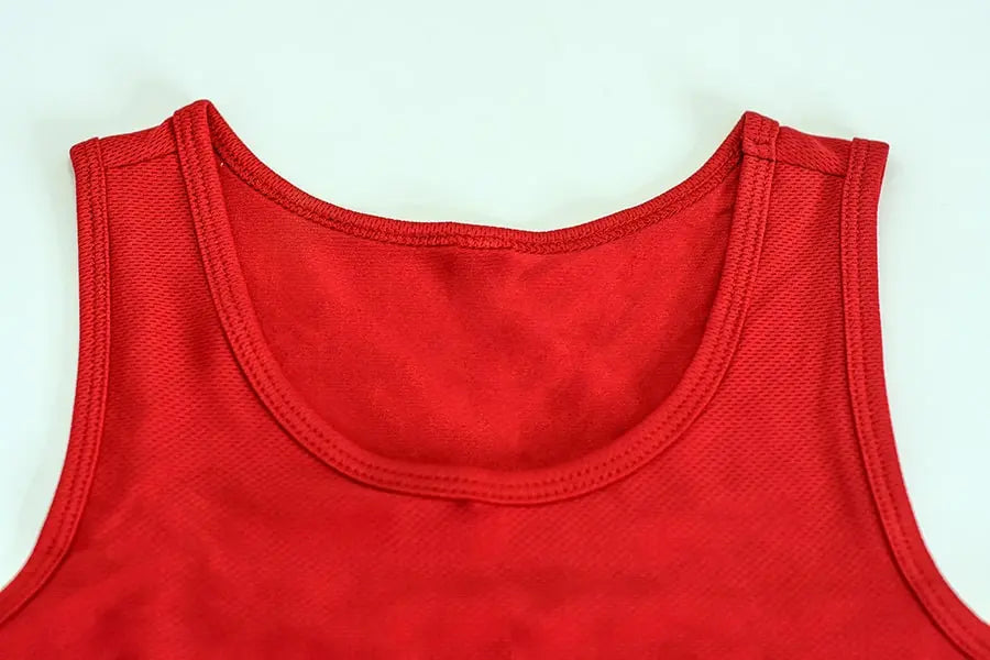 Front view of the scoop neckline on a red TOMSCOUT chest binder, highlighting its clean stitching and smooth, tagless inner lining. Crafted for androgynous individuals seeking breathable compression wear, this binder offers a soft-touch feel against the skin while providing a discreet, gender-affirming silhouette. Available through TOMSCOUT’s Free Chest Binder Program.