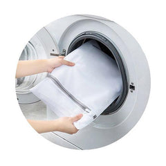 Hands placing a white mesh laundry bag into a front-load washer—ideal for protecting TOMSCOUT binders and gender-affirming underwear during wash cycles. Helps preserve compression integrity and prevent snags or stretching.