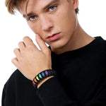 Stylish model elegantly wearing the TOMSCOUT LGBTQ+ Pride Paracord Bracelet with a striking rainbow design, a sustainable and fashionable accessory for expressing LGBTQ+ pride and solidarity.