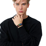 Stylish model elegantly wearing the TOMSCOUT LGBTQ+ Pride Paracord Bracelet with a striking rainbow design, a sustainable and fashionable accessory for expressing LGBTQ+ pride and solidarity.