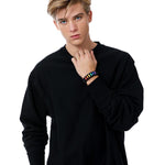Stylish Model Wearing TOMSCOUT LGBTQ+ Pride Paracord Bracelet - Rainbow Design.