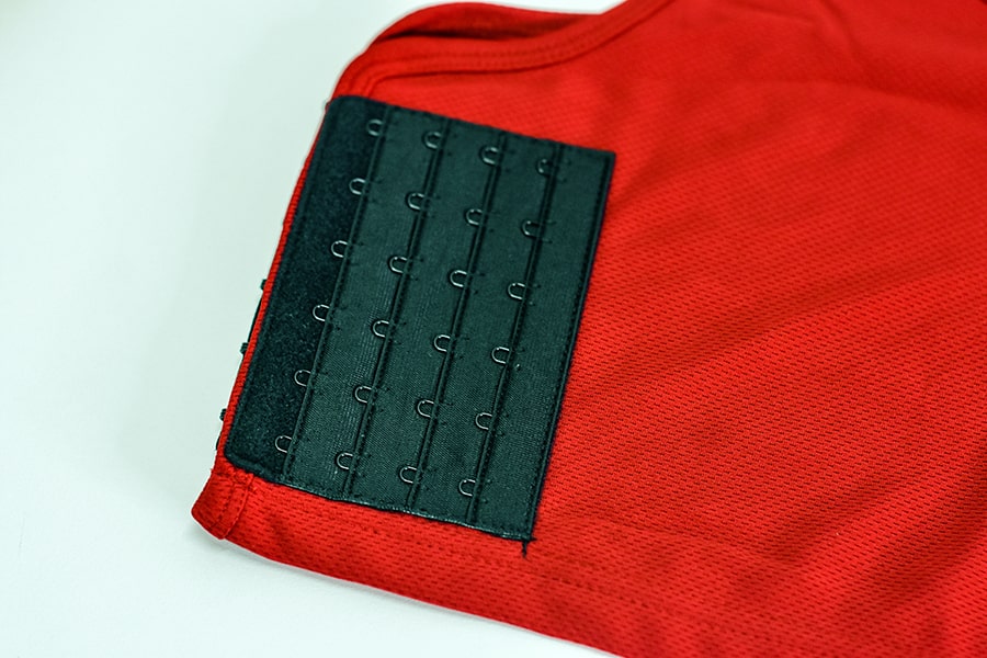 The product details of a scarlet red color non-bandage chest binder | TOMSCOUT The Freedom Binder, Free Chest Binder Program