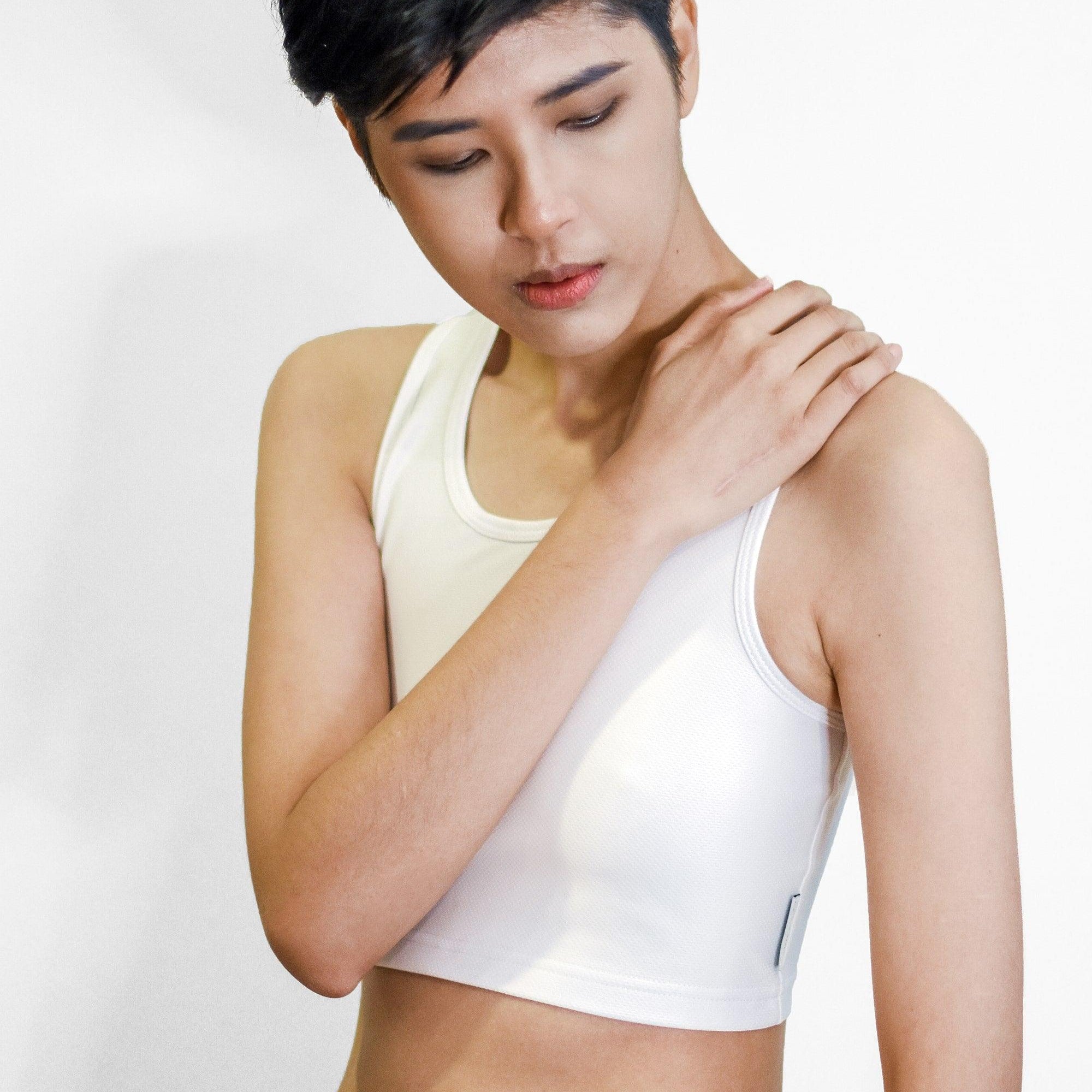 Non-binary Tomboy in a white color non-bandage TOMSCOUT Chest Binder, part of the TOMSCOUT ACTIVE BINDER collection, showcasing a clearance binder that's affordable yet high quality.