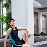 A non-binary androgynous tomboy, transgender man wearing a black color of a bandage TOMSCOUT Swimming Chest Binder to fight body dysphoria and swimming in the pool, TOMSCOUT SAPPHIRE SWIMMING BINDER.