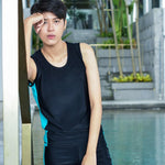 A non-binary androgynous tomboy, transgender man wearing a black color of a bandage TOMSCOUT Swimming Chest Binder to fight body dysphoria and swimming in the pool, TOMSCOUT SAPPHIRE SWIMMING BINDER.