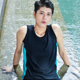 A non-binary androgynous tomboy, transgender man wearing a black color of a bandage TOMSCOUT Swimming Chest Binder to fight body dysphoria and swimming in the pool, TOMSCOUT SAPPHIRE SWIMMING BINDER.