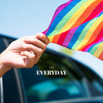 Vivid image capturing a hand flaunting a TOMSCOUT LGBT rainbow pride bandana during a road trip. This picture resonates with adventure-loving individuals in Singapore's LGBT community, highlighting the bandana as a symbol of journey and pride.