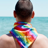 A young male wearing a LGBT rainbow pride bandana on the back at the seaside. TOMSCOUT LGBTQ+ Pride Bandana