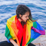 A young girl cover her back with a LGBTQ Rainbow Pride Flag. TOMSCOUT LGBTQ+ Classic Pride Flag
