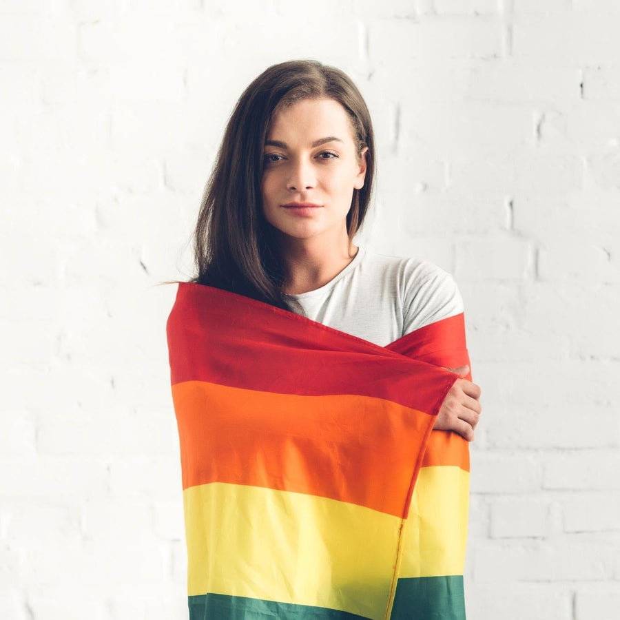 A young women cover her body with a LGBTQ Rainbow Pride Flag, TOMSCOUT PRIDE  RAINBOW FLAG.