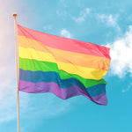 A waving colorful LGBTQ Rainbow Pride Flag on the sky. TOMSCOUT LGBTQ+ Classic Pride Flag