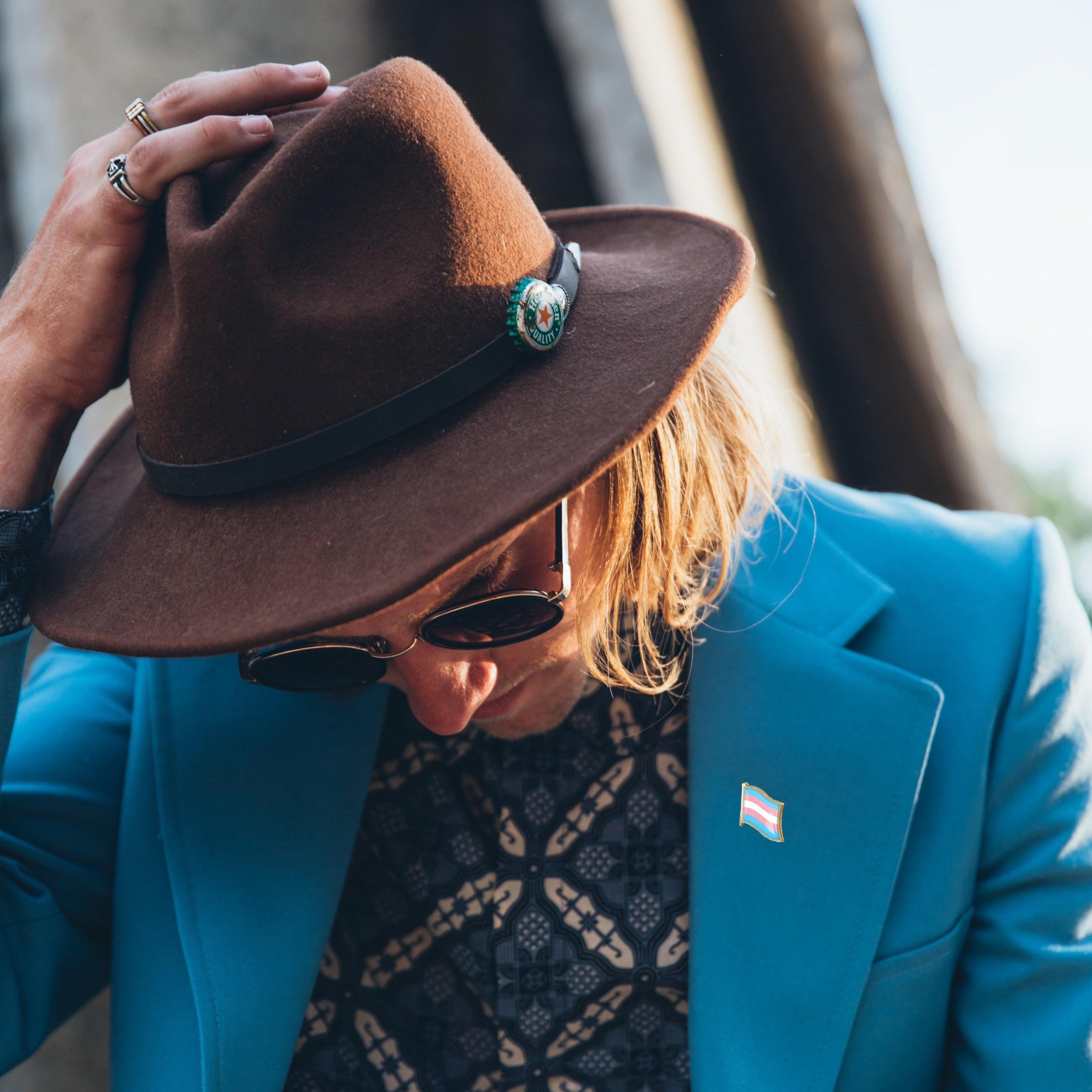 Model demonstration in the TOMSCOUT lookbook, featuring the LGBTQ+ Pride Metal Badge prominently pinned on a shirt. This image showcases the badge as a proud symbol of identity and solidarity within the LGBT community, perfect for transgender men, non-binary individuals, and tomboys in Singapore seeking to visibly express their pride and connection.